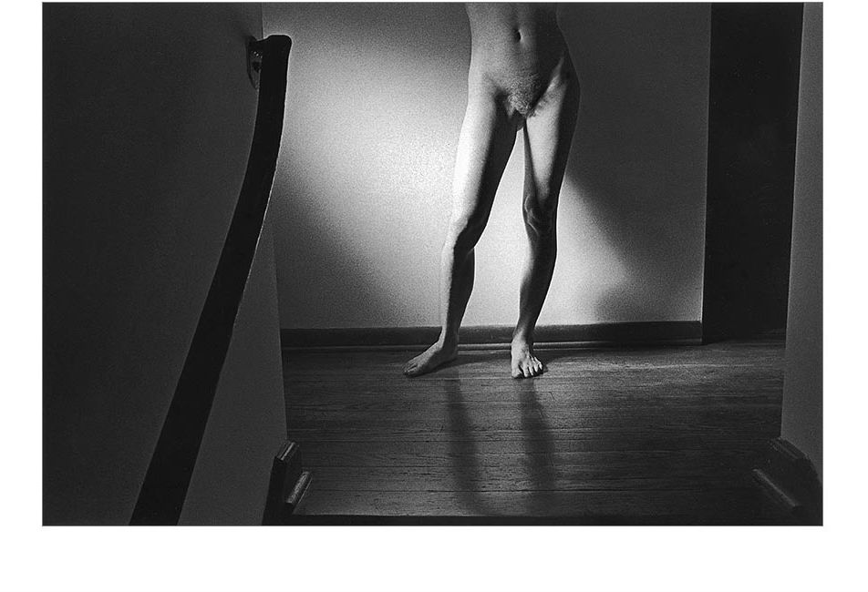 Photo of nude at top of the stairs.